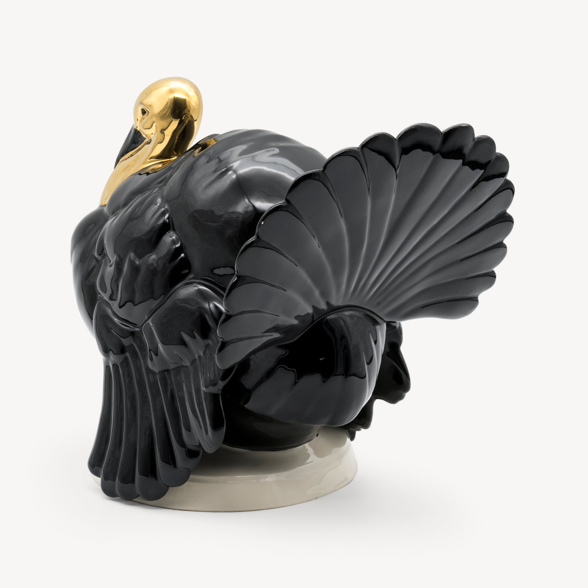 Rear three-quarter view showing the layered plumage and raised tail of the black Goebel turkey sculpture.