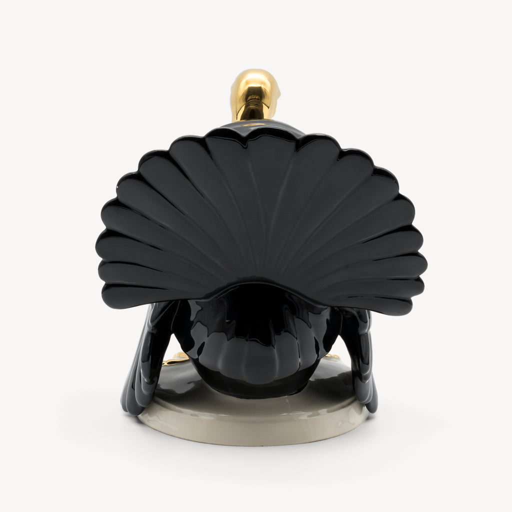 Rear view of the Goebel porcelain turkey with its sculpted black fan-shaped tail.