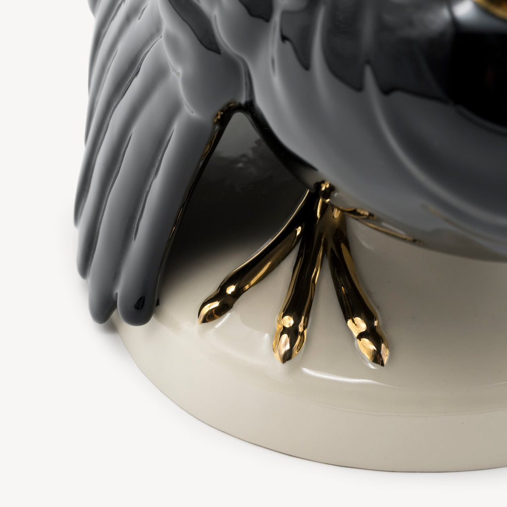 Close-up of the gilded claws and glossy black feather detail on the Goebel turkey sculpture.
