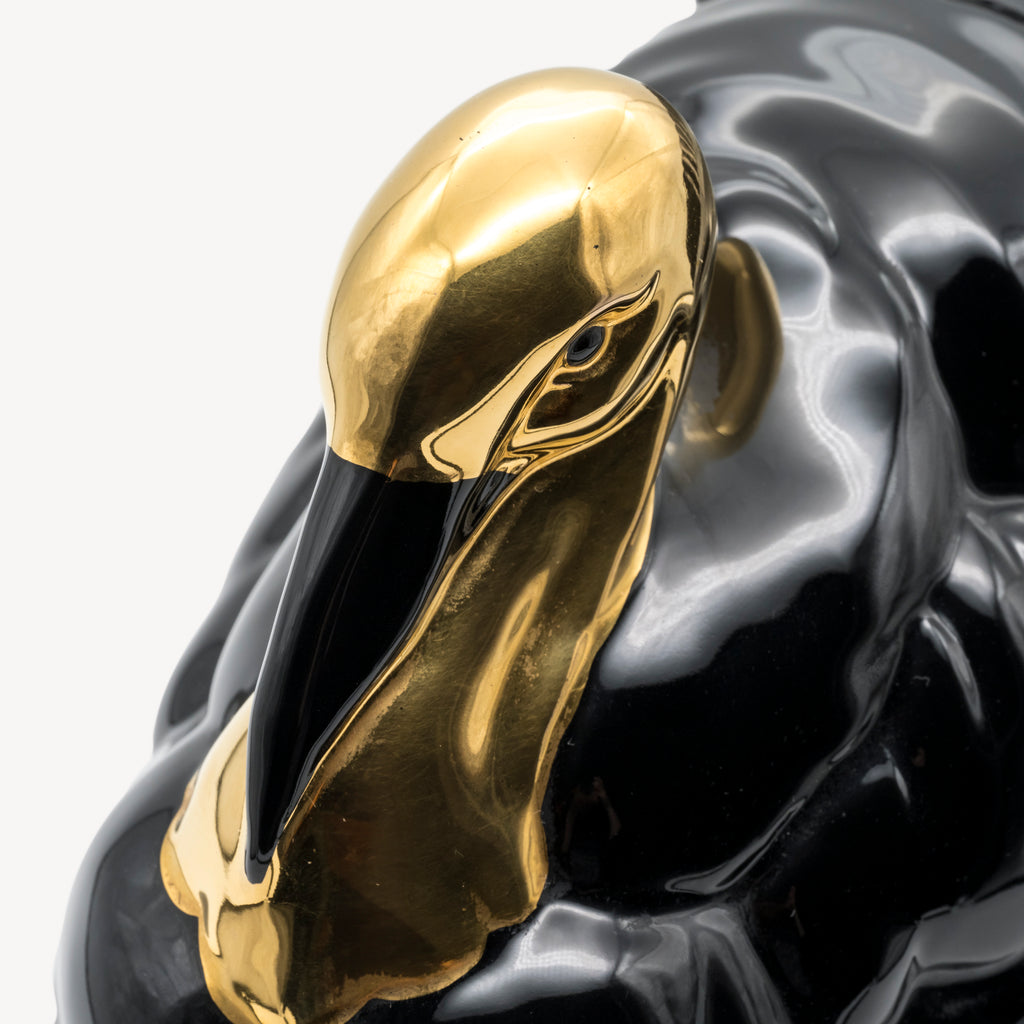 Close-up of the reflective gold head and detailed facial features of the Goebel turkey sculpture.